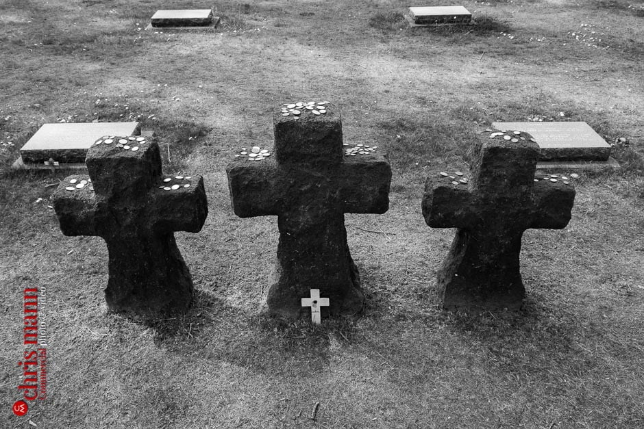 Visitors of many nationalities have placed coins on top of these crosses as tributes to the dead.