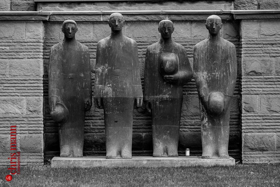 At the front of Langemark cemetery is a sculpture of four mourning figures by Professor Emil Krieger. The group was added in 1956, and is said to stand guard over the fallen.